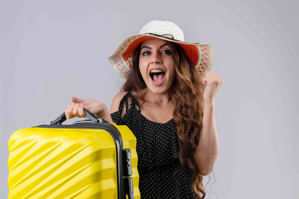 girl-holding-suitcase-looking-exited.jpg