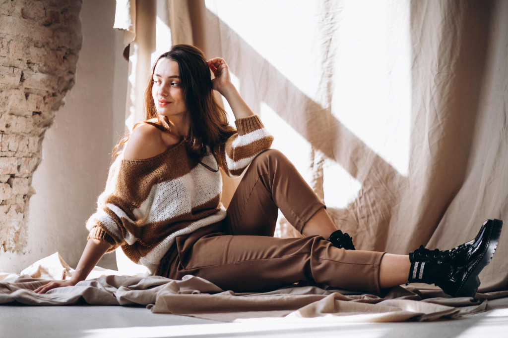 young-woman-warm-sweater-sitting-ground.jpg